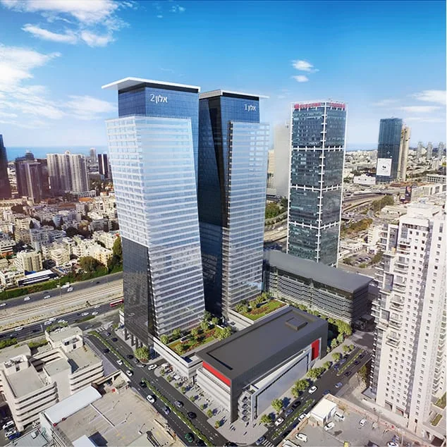 תצלום אווירי מציג שני מגדלי משרדים גבוהים מזכוכית באזור עסקי צפוף