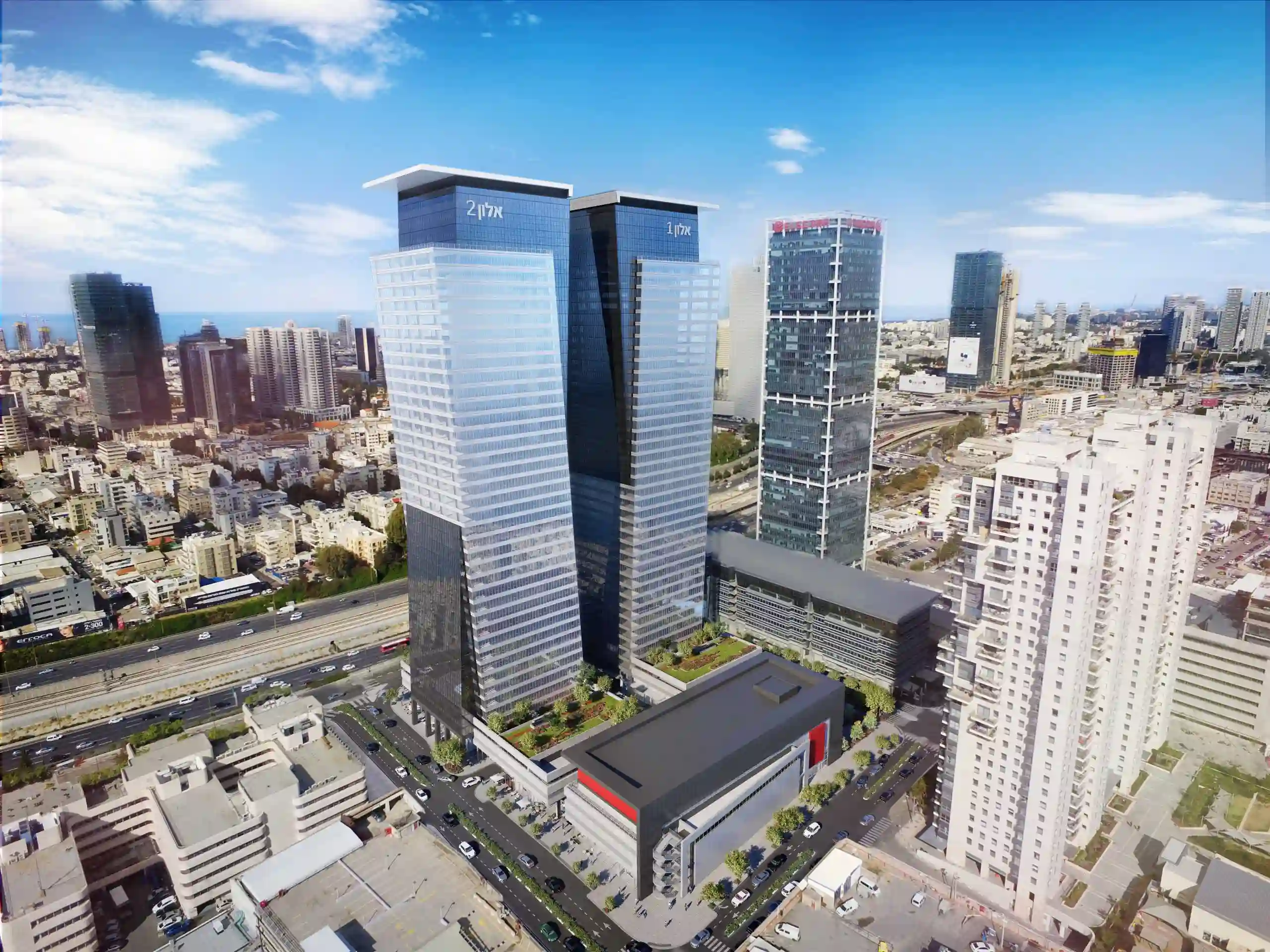 מבט אווירי על שני מגדלי משרדים מעל כביש מהיר ונוף עירוני